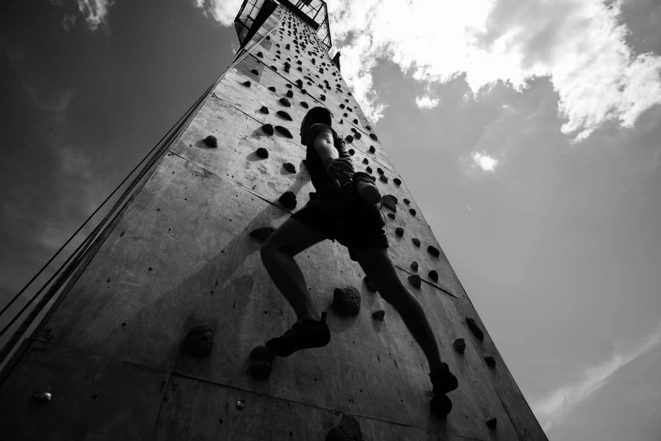 Young man exercising indoor climbing a wall